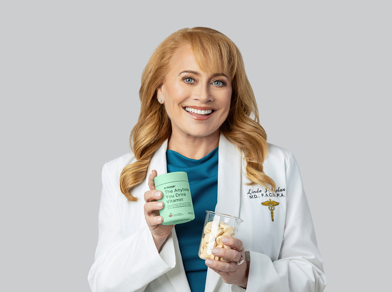 H-Proof co-founder Dr Linda Kaplan holding H-Proof Drink Vitamin