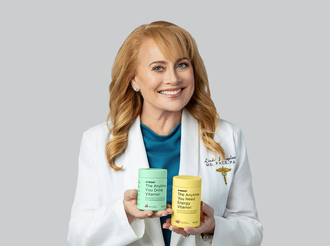 H-Proof co-founder Dr Linda Kaplan holding H-Proof vitamins