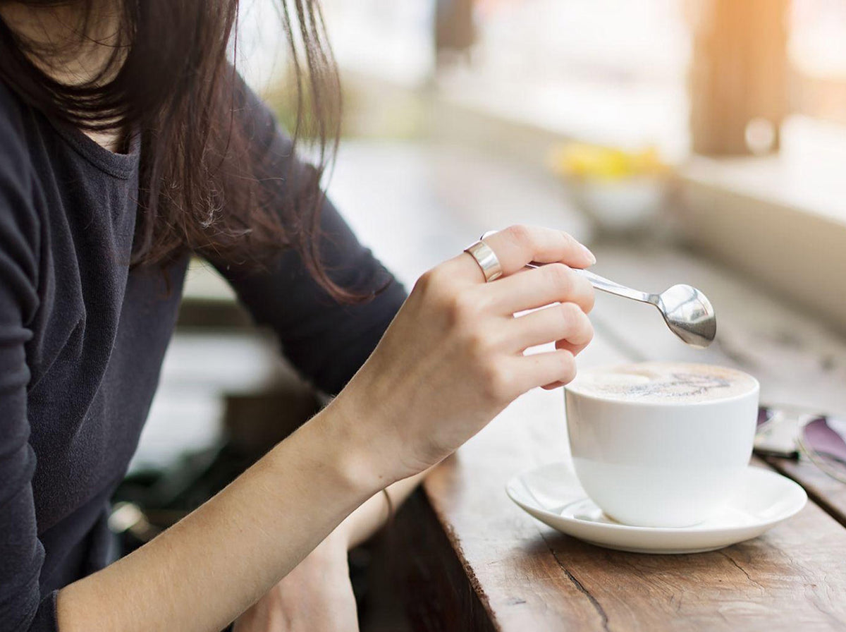 woman stirring coffee drink